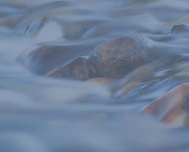 River rocks with water flowing image on recovery house website.